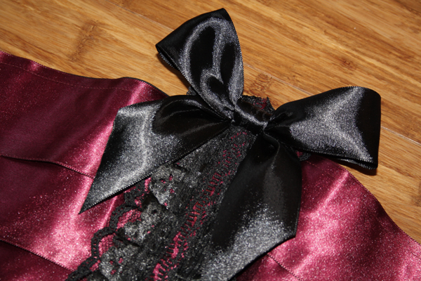 Black lace detail on purple satin ribbon corset.