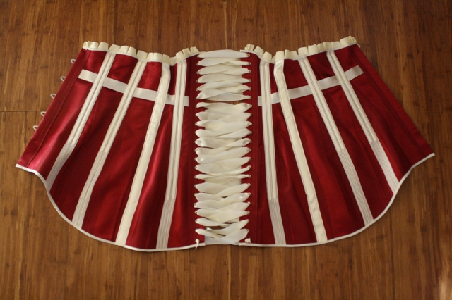 Inside of red striped satin 1911 long line corset with cream satin trimmings and cream satin laces